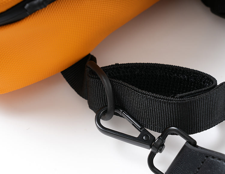 Close-up of orange handlebar bag strap with black clip and hook attachment