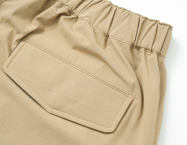 Beige relaxed-fit drawstring cargo pants with flap pocket detail