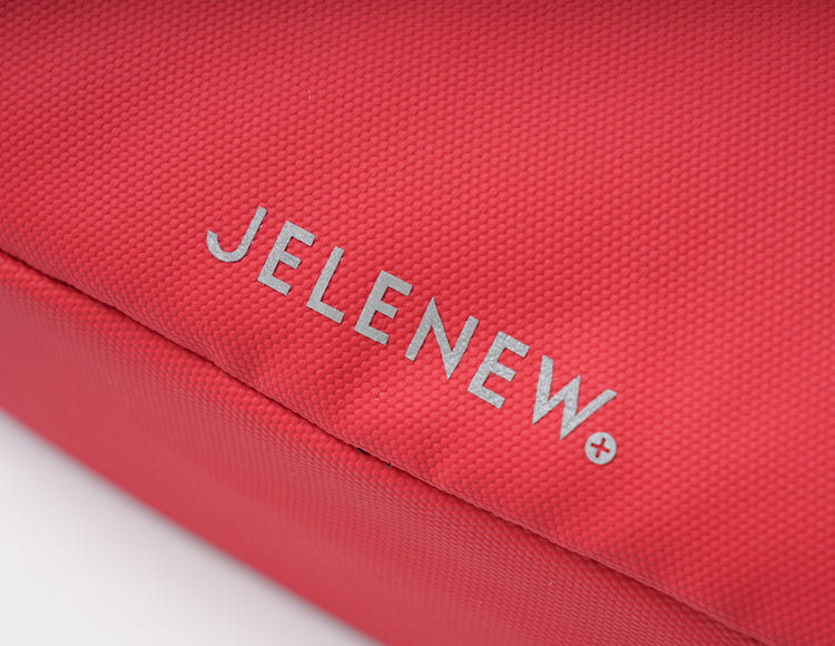Close-up of red JELENEW handlebar bag with textured fabric and logo detail