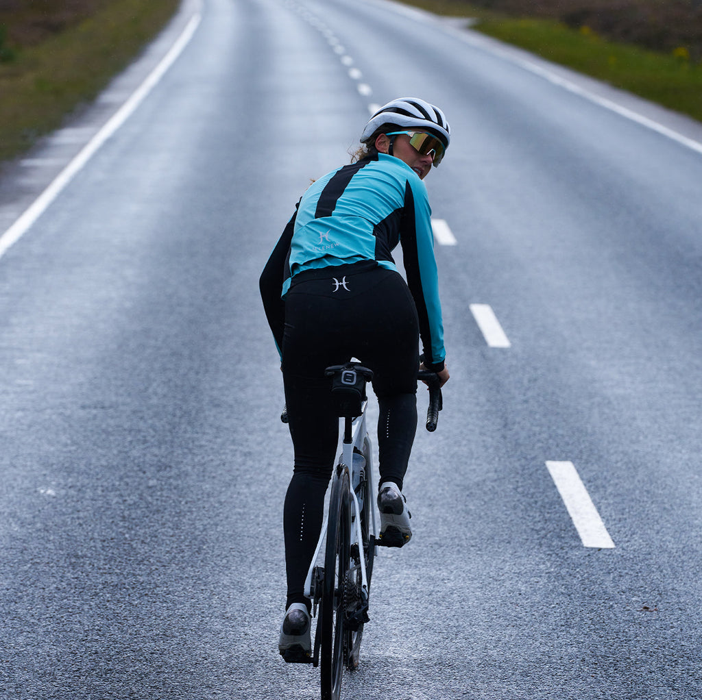 cyclist wearing 3L Core Rain Jacket riding on wet road under overcast sky