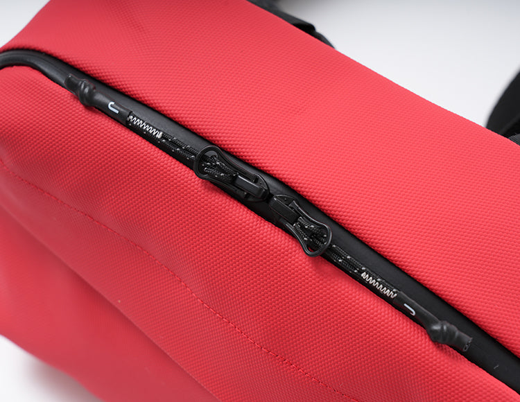 Red handlebar bag with durable fabric and black zipper closure for organized storage