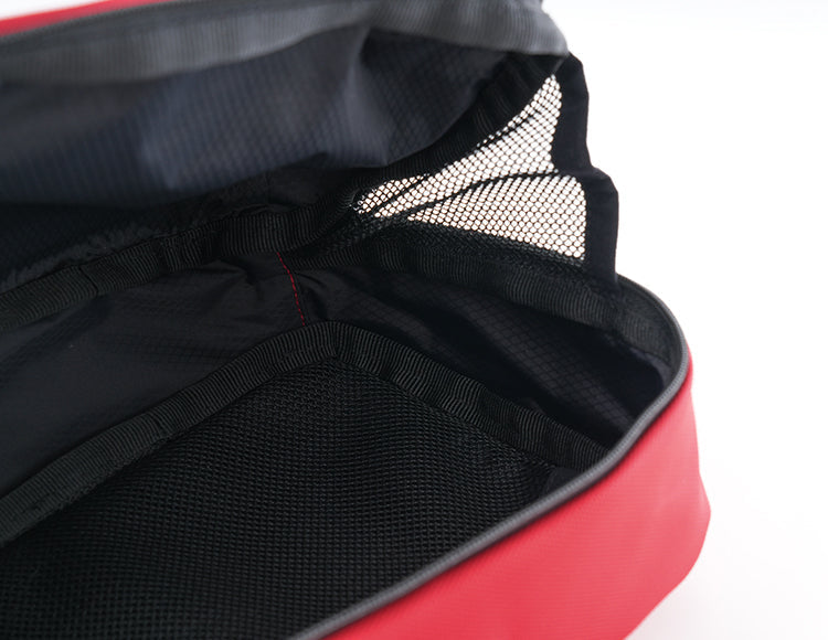 Red handlebar bag with compartmentalized black mesh interior for organized storage